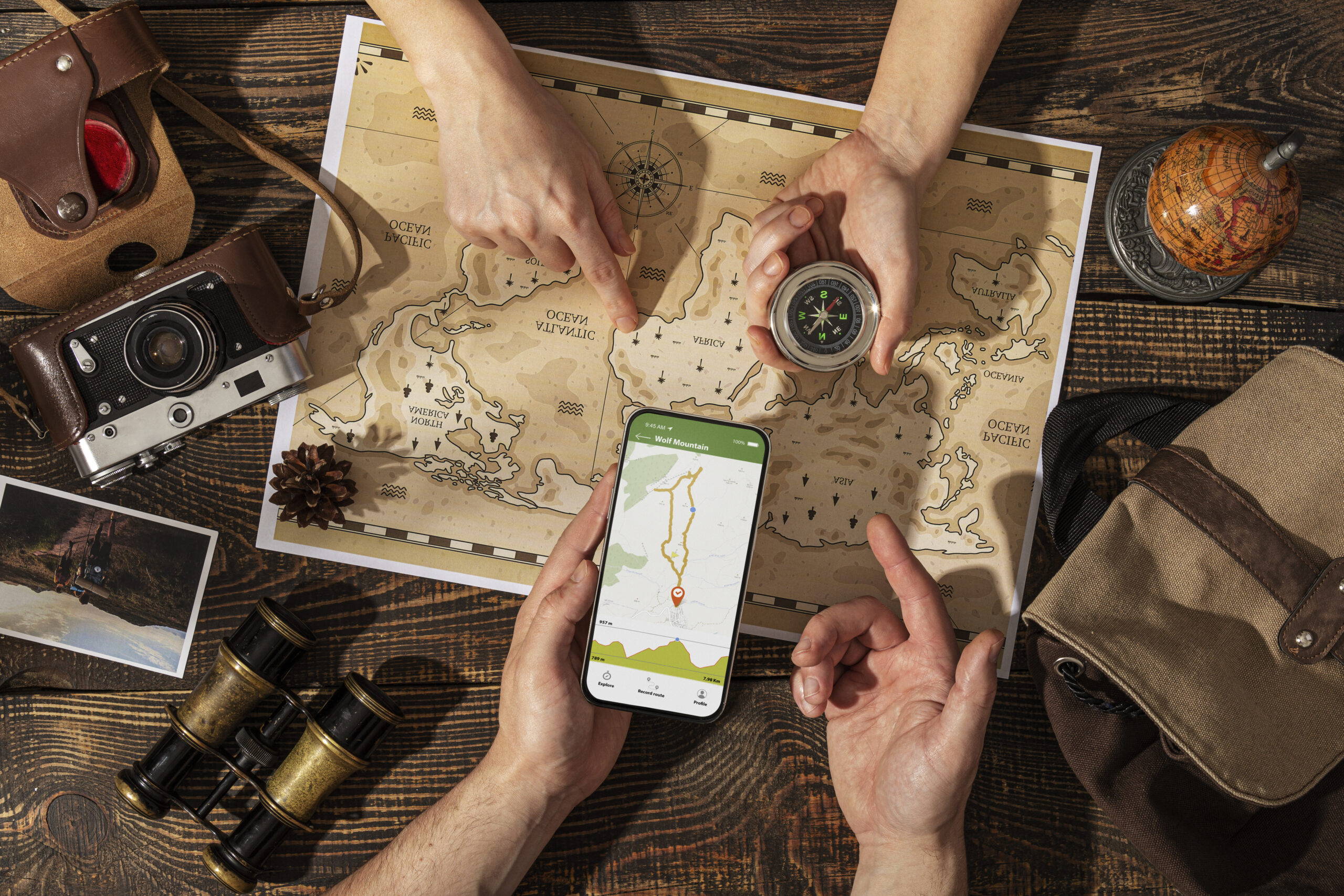 top view hands holding compass smartphone scaled